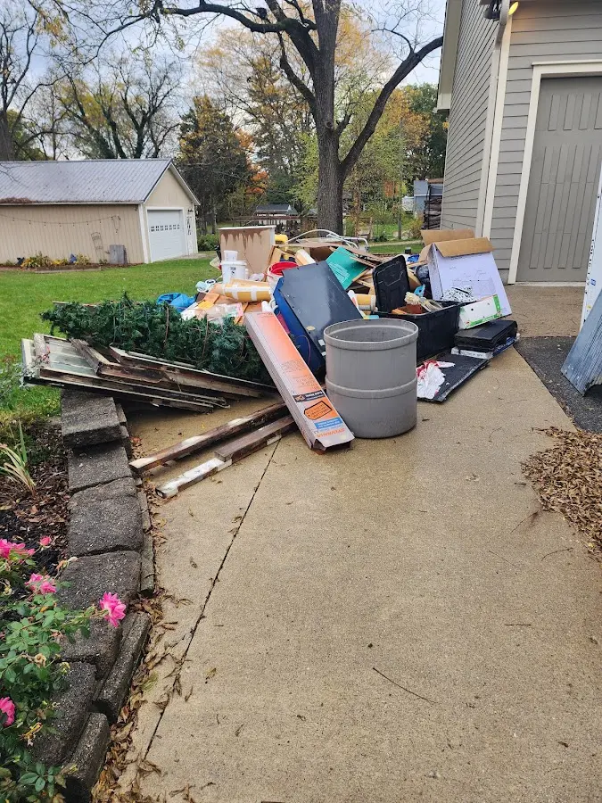 Dumpster being loaded with debris for Roofing Dumpster Rental in Wilmore